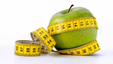 A green apple being measured. Eating more fruits and vegetables can help keep with weight management.